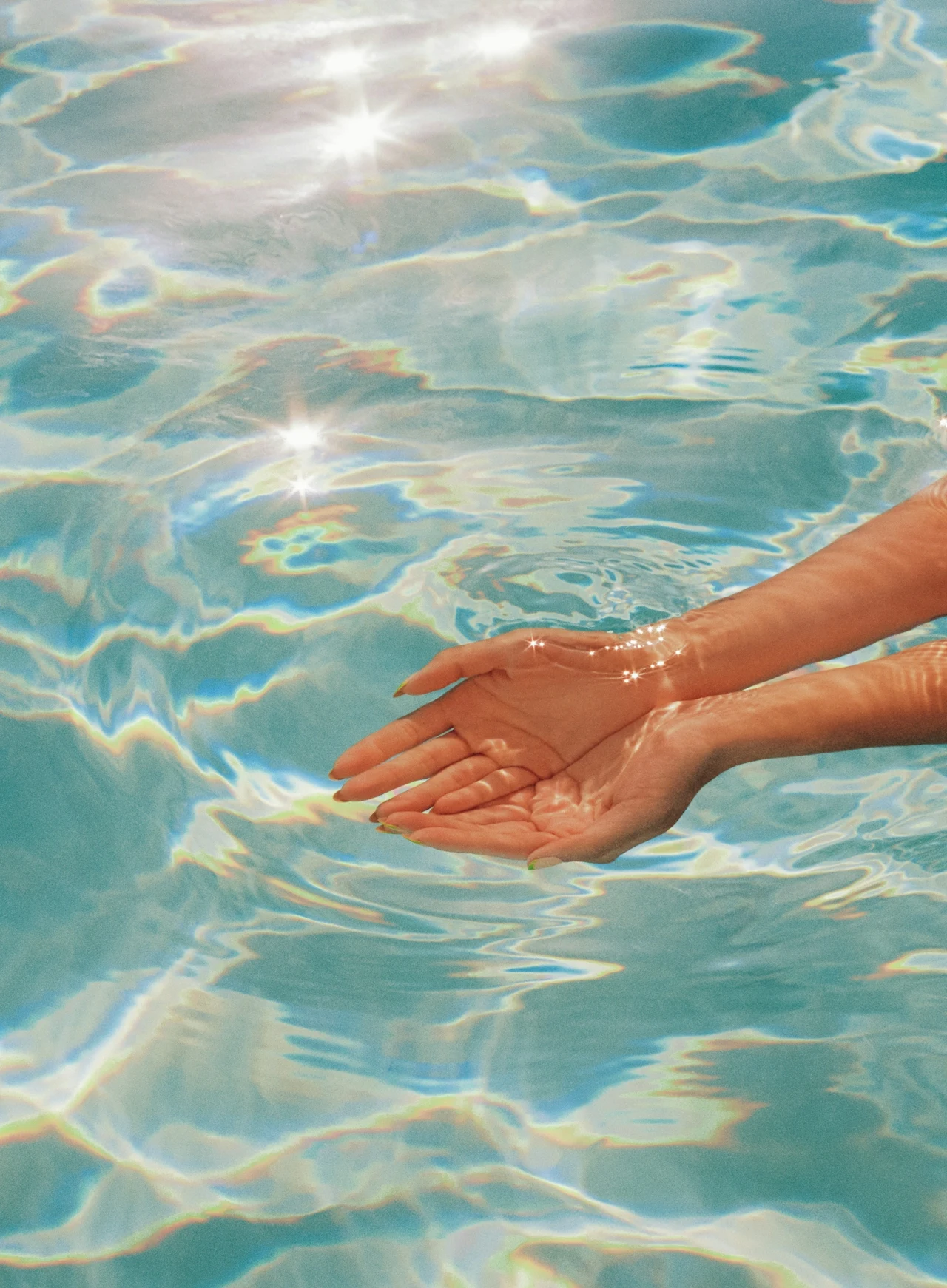 Hands resting in sunlit water